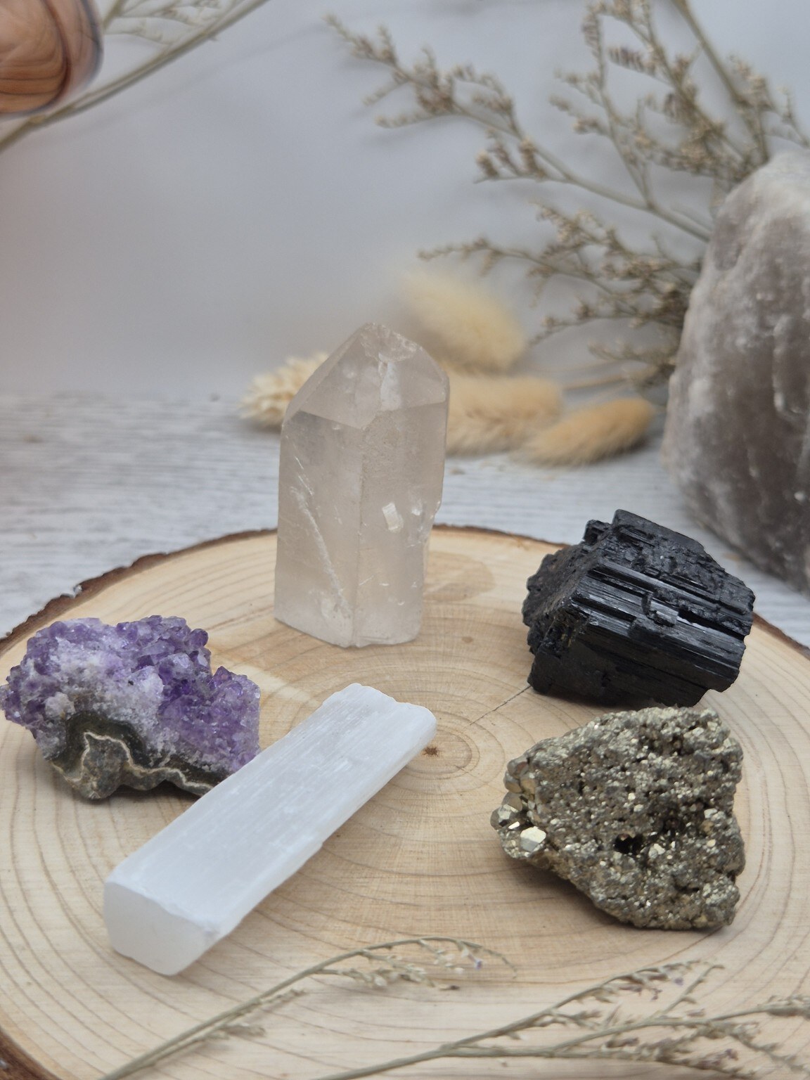 Amanda’s handpicked crystal collection arranged naturally on wood