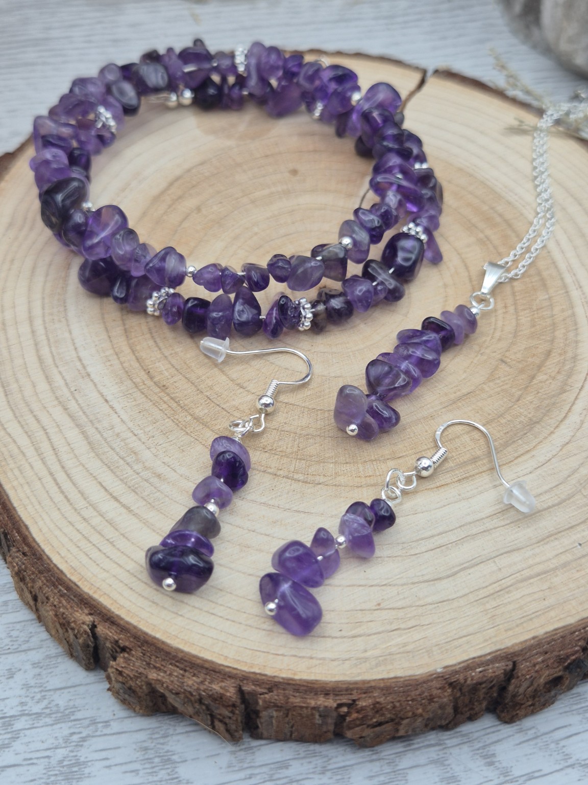Handmade amethyst jewellery set on natural wood